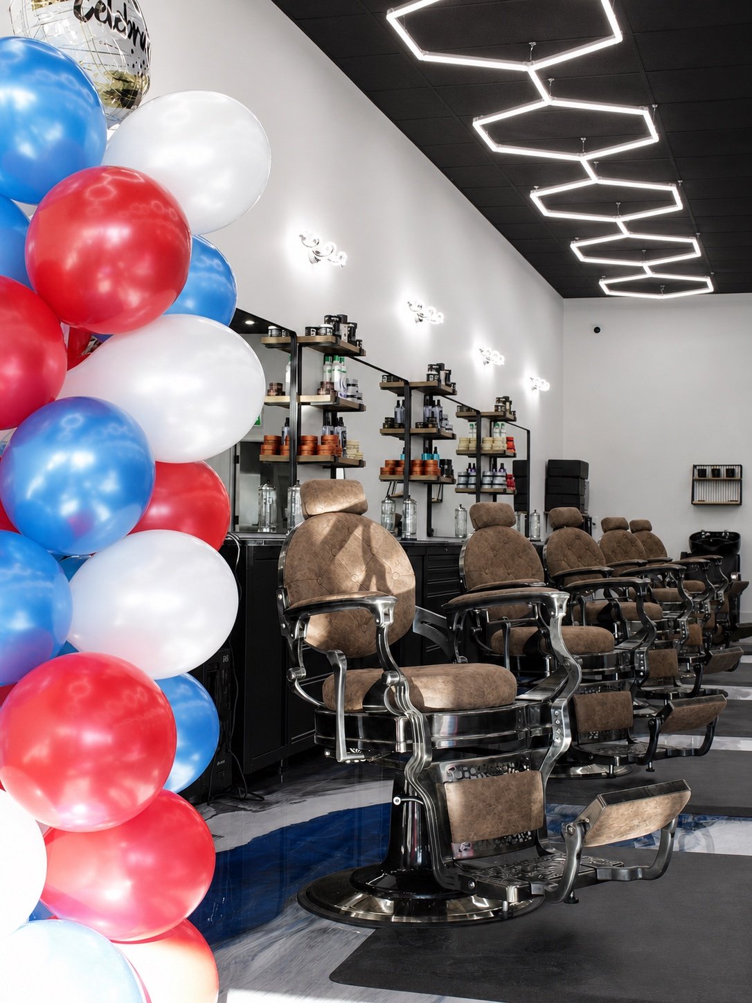 TopTown Barbershop decorated for opening day with balloons beside the barber chairs