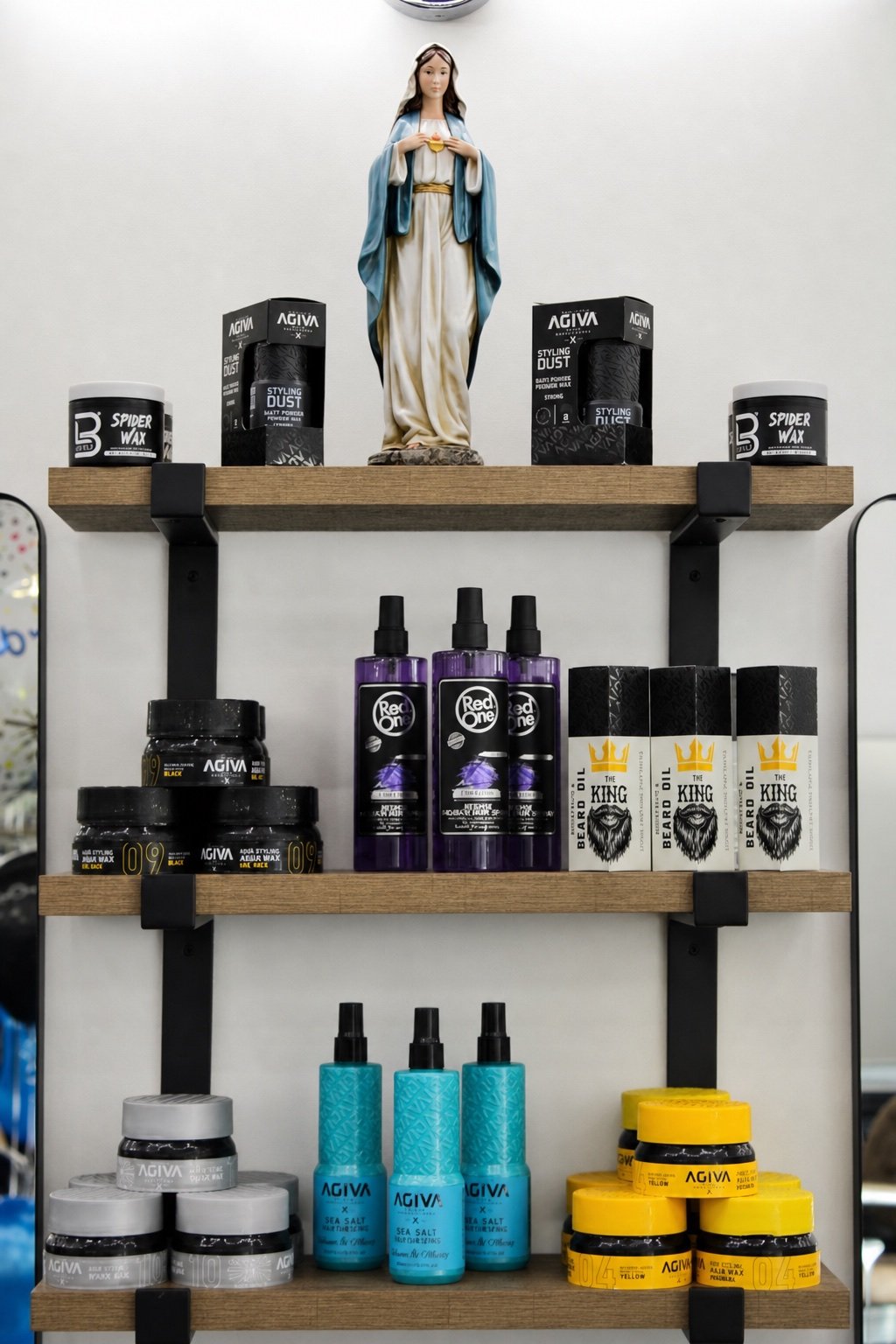 TopTown Barbershop grooming products arranged on wood and black metal shelves